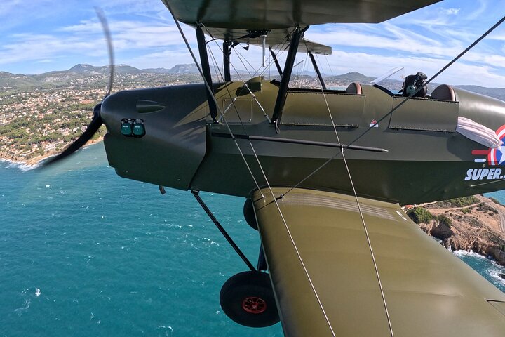 New Biplan flying low over Marseille Bay , gorgeous calanques. 